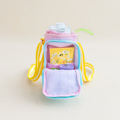 Tissue packet and candy being stored in the front pocket of a water bottle bag.