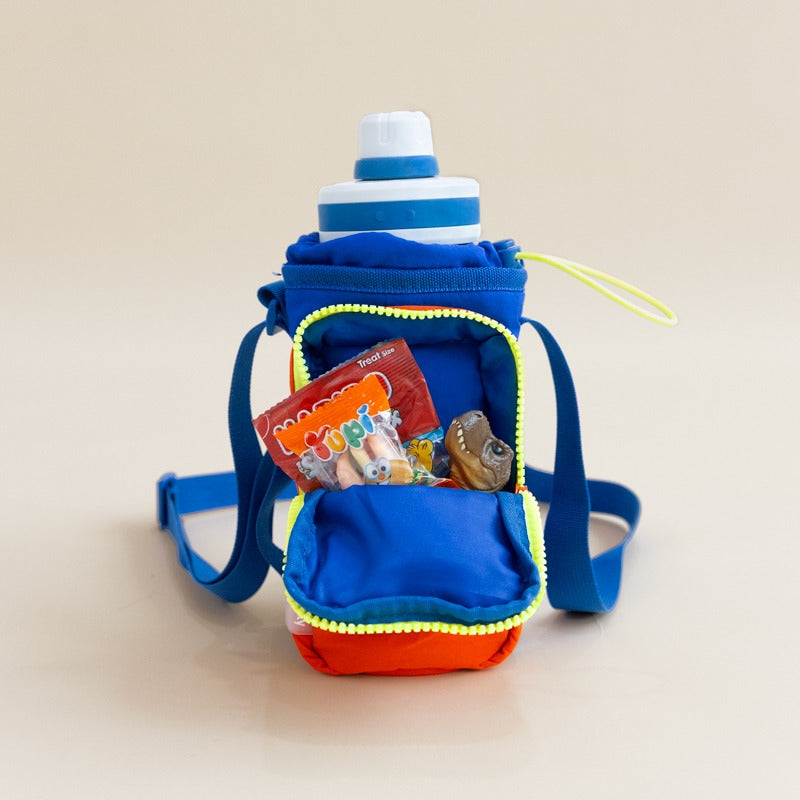Snacks and toys being stored in the front pocket of a water bottle bag 