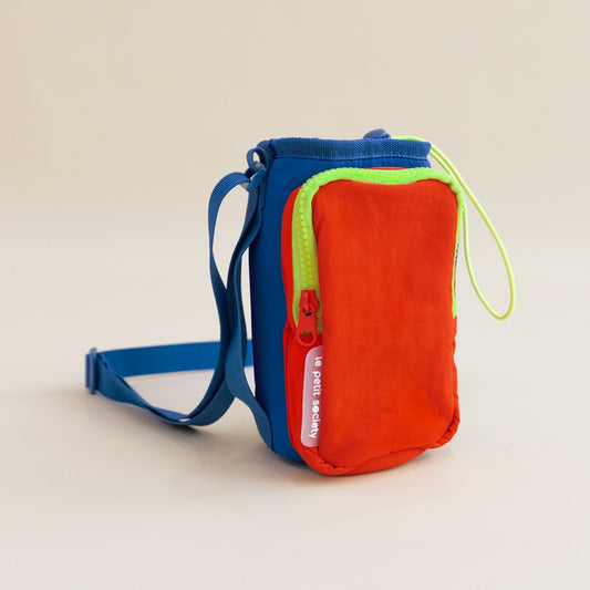 A colourblock water bottle sling bag with an adjustable strap and a front pocket