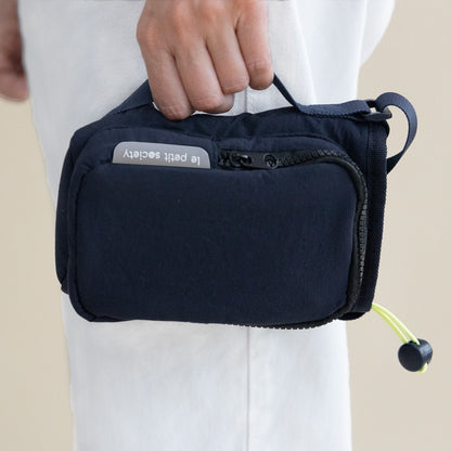 A hand carrying a water bottle bag with a side handle
