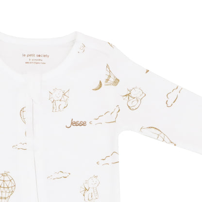 A close-up of a name embroidery personalisation on an organic zip sleepsuit in dragon print by Le Petit Society.