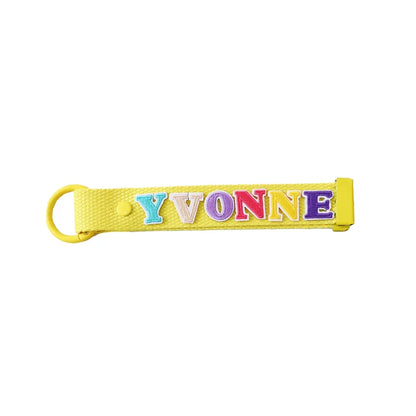 Le Petit Society's yellow bag tag customised with name patches.