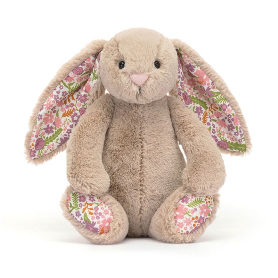 A front view of a small soft beige plush bunny with long floppy ears lined in floral fabric, a pink nose and gentle eyes. The same pretty floral pattern decorates its feet. 