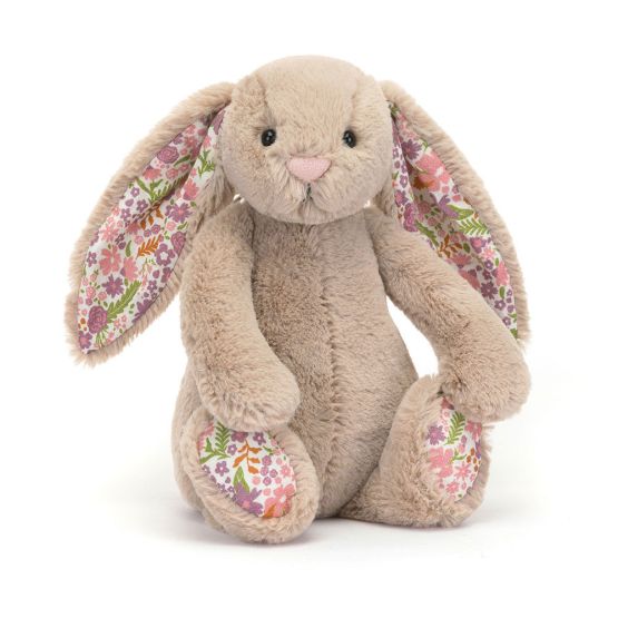 A front view of a small soft beige plush bunny with long floppy ears lined in floral fabric, a pink nose and gentle eyes. The same pretty floral pattern decorates its feet. 
